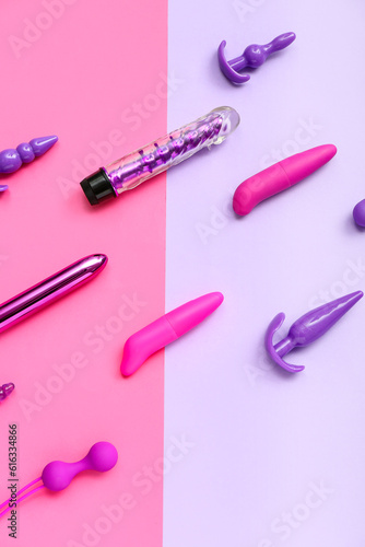 Vibrators with anal plugs on color background