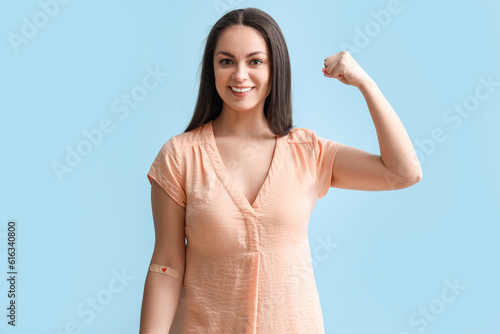 Female donor with applied medical patch showing muscles on blue background photo