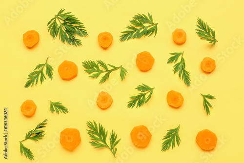 Fototapeta Naklejka Na Ścianę i Meble -  Slices of fresh carrots on yellow background