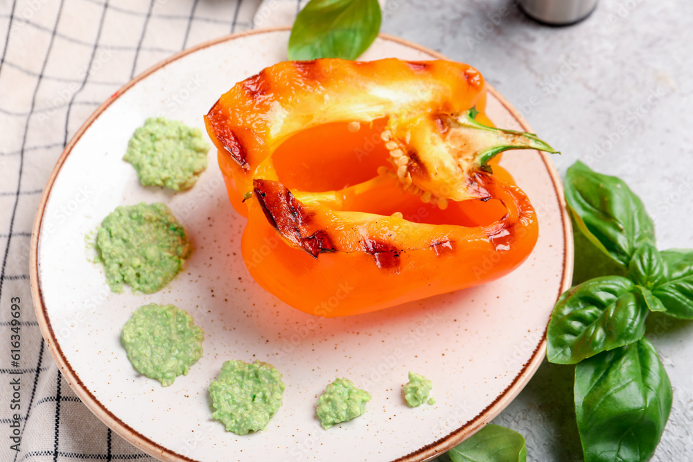 Plate with tasty grilled bell pepper on grey background Plate with tasty grilled bell pepper on grey background