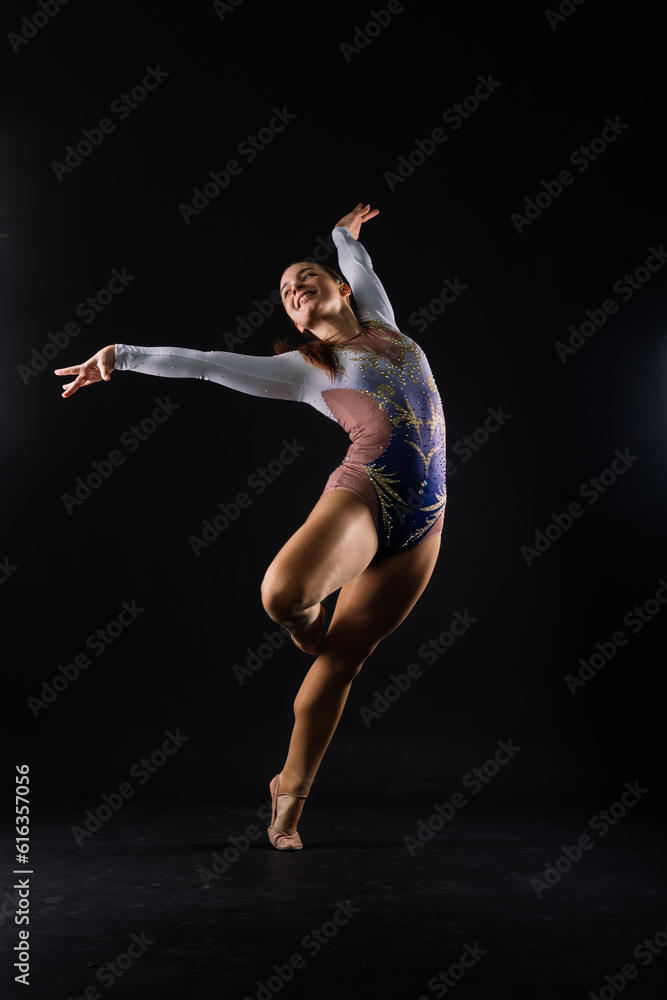 Full length portrait of plump woman doing physical exercise, jumping, white and black background.