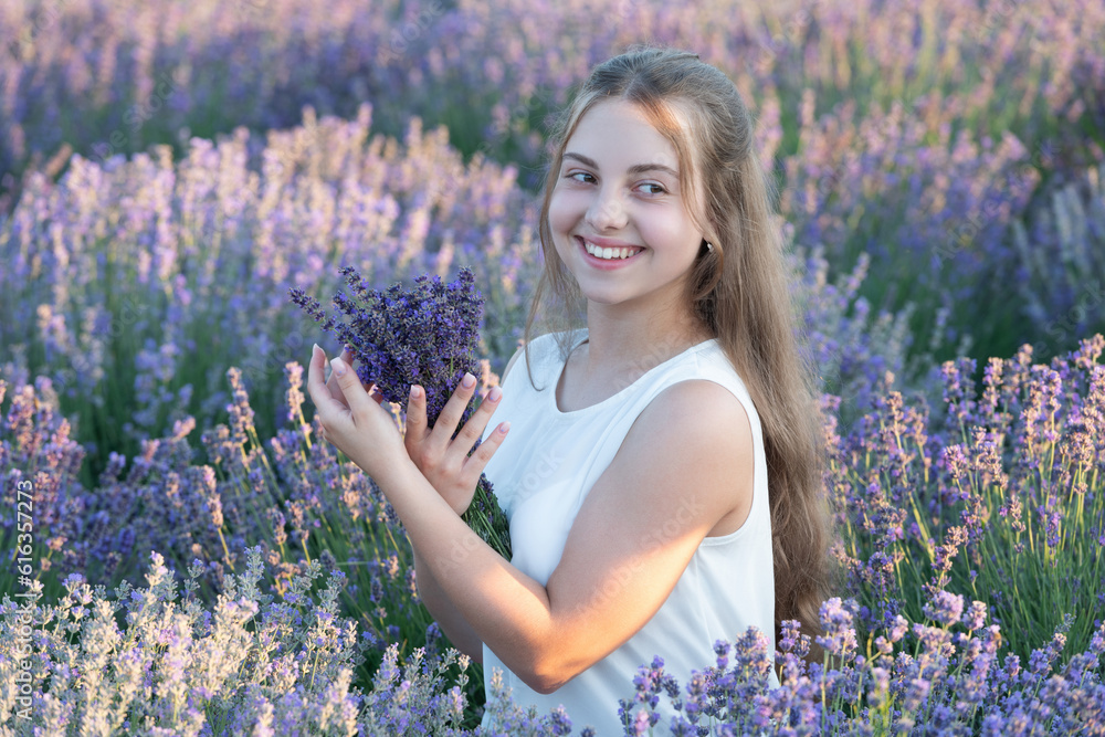 Beautiful girl smile in lavender flowers field. teen girl holding a ...