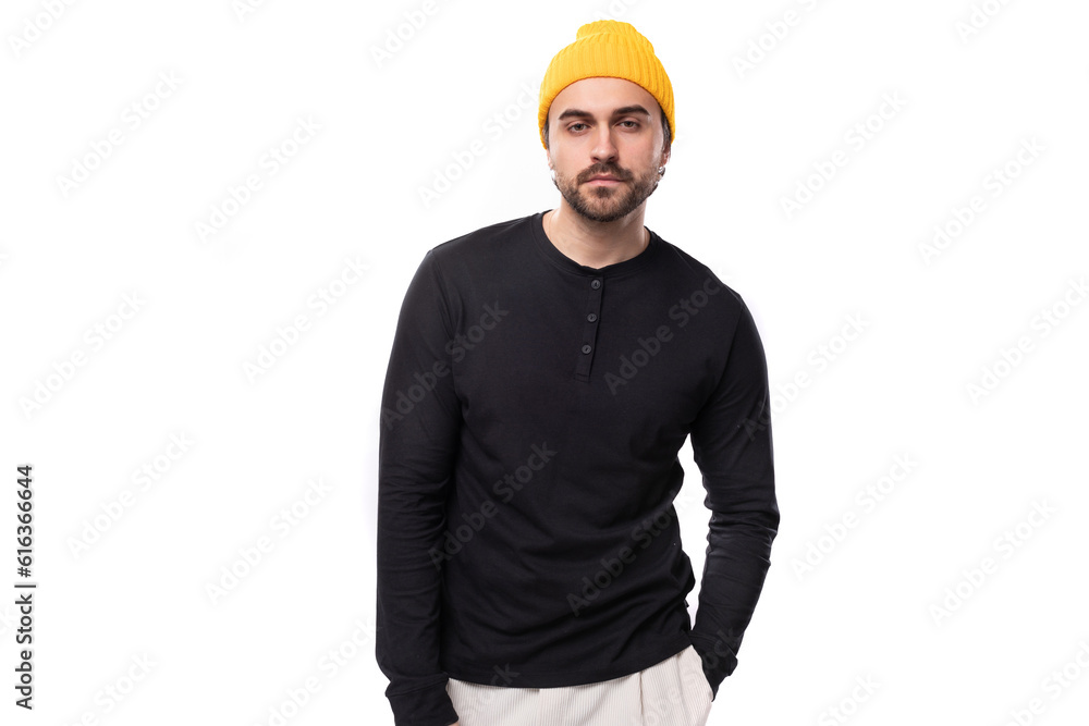 handsome 30s authentic brunet male adult in black sweatshirt posing as model on white background with copy space handsome 30s authentic brunet male adult in black sweatshirt posing as model on white background with copy space