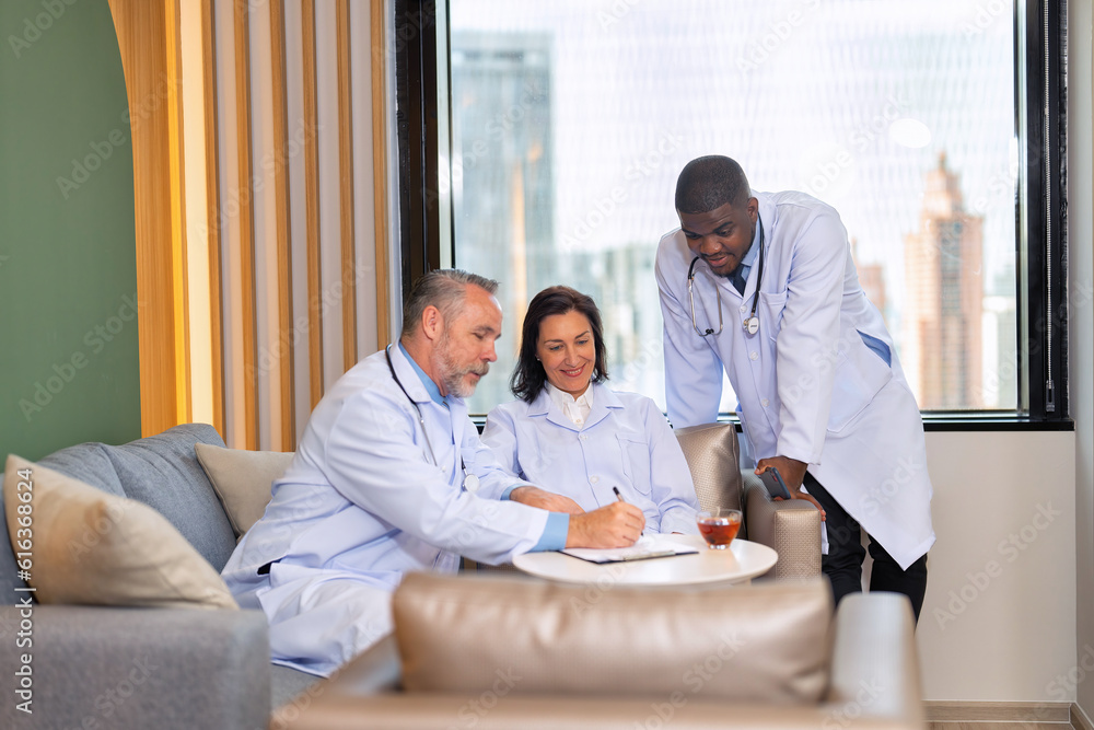Healthcare doctors sitting on sofa in pantry room at modern hospital relax briefing patient case Healthcare doctors sitting on sofa in pantry room at modern hospital relax briefing patient case