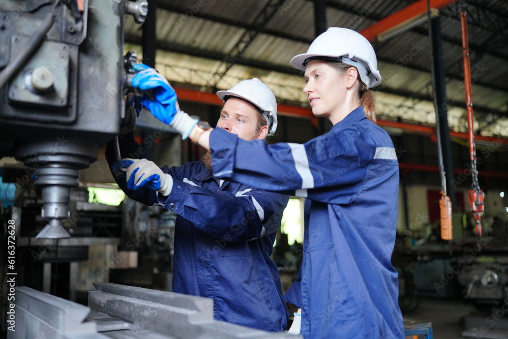 Industrial Engineer at work in factory, industrial engineers working at automated AI robotic production factory - New technology concept Industrial Engineer at work in factory, industrial engineers working at automated AI robotic production factory - New technology concept