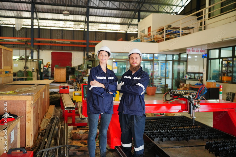Industrial Engineer at work in factory, industrial engineers working at automated AI robotic production factory - New technology concept Industrial Engineer at work in factory, industrial engineers working at automated AI robotic production factory - New technology concept