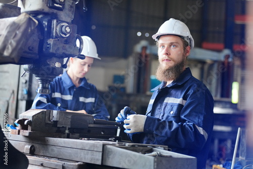 Industrial Engineer at work in factory, industrial engineers working at automated AI robotic production factory - New technology concept