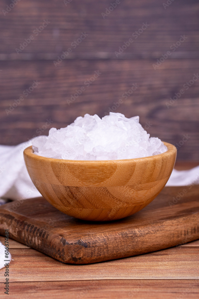 Lemon salt or Citric acid on wood background. Citric acid or lemon salt in wooden bowl Lemon salt or Citric acid on wood background. Citric acid or lemon salt in wooden bowl