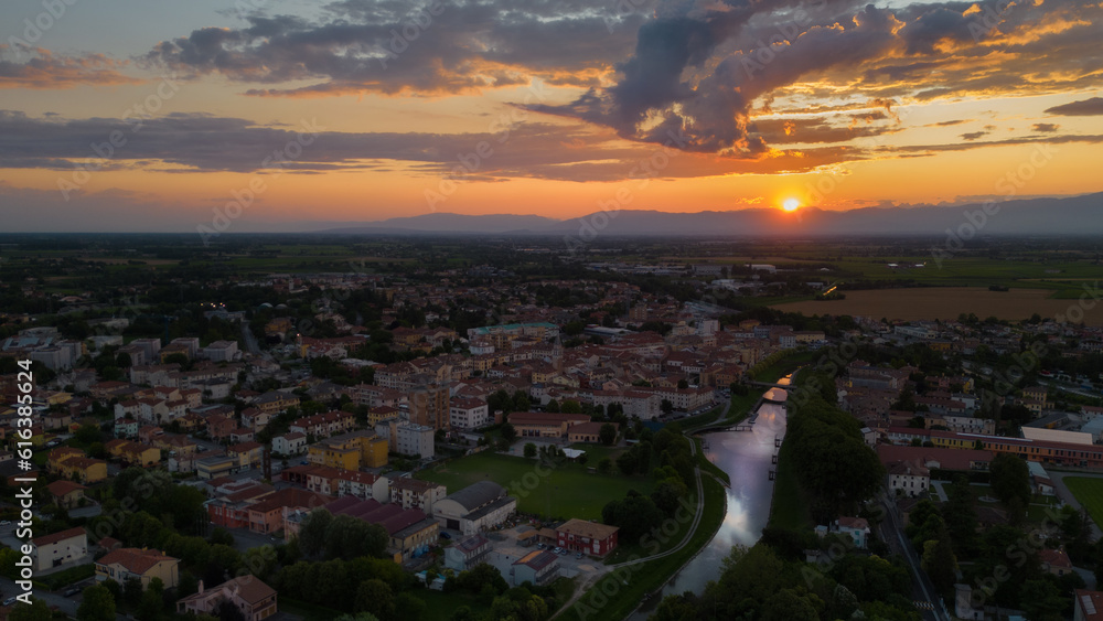 Spectacular sunset in an Italian town with Livenza river, Motta di Livenza Veneto