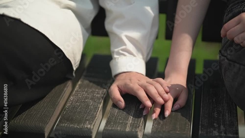 hands.touch.close-up..teenager and teenage girl on a park bench. first relationship.teenage date.Full HD quality video recording