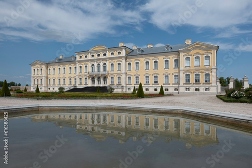 Rundale Palace in the Bauska Municipality in Latvia. Baroque yellow building reflected in the water of the pond. Famous tourist attraction