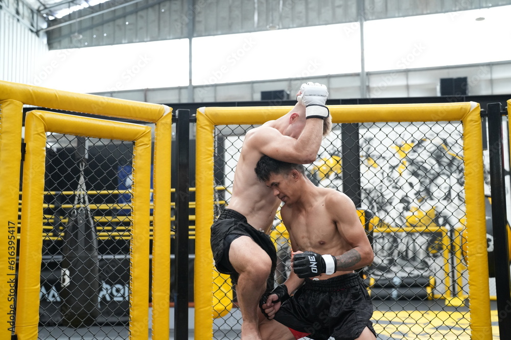 © FotoArtist - Two professional boxers fighting at the gym
