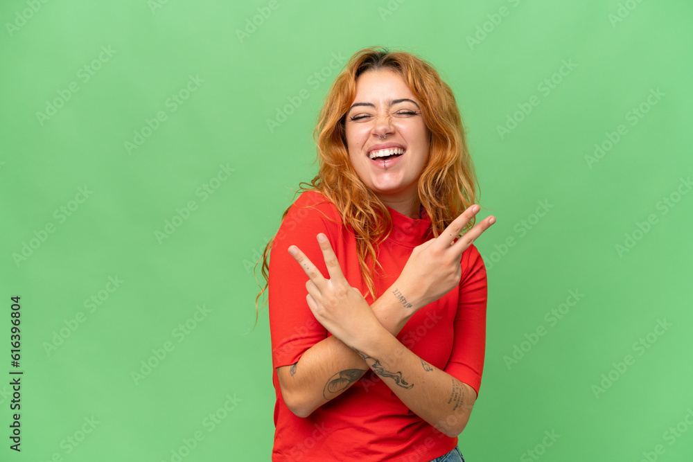 Young caucasian woman isolated on green screen chroma key background smiling and showing victory sign Young caucasian woman isolated on green screen chroma key background smiling and showing victory sign