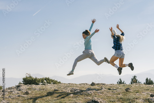 Sexy happy girls having fun on top of the mountain