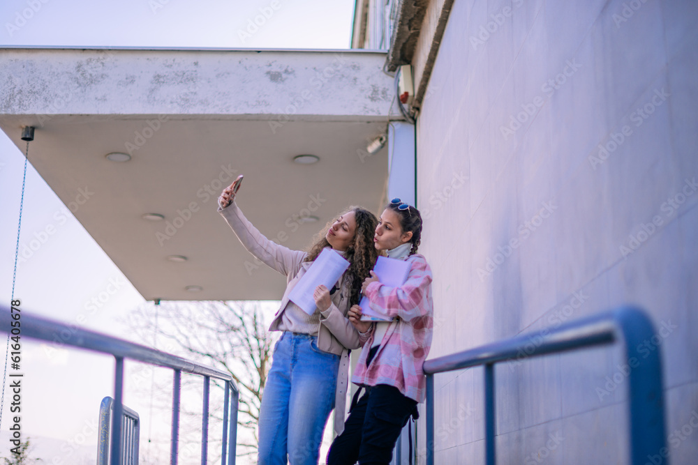 School girls taking a selfie at the school yard