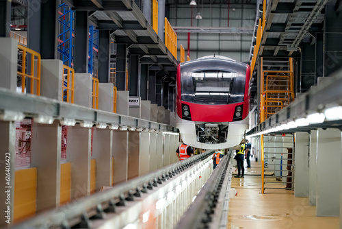 Railway Worker Goes Along the Train with a Check. Portrait of apprentice in workshop of railway engineering facility