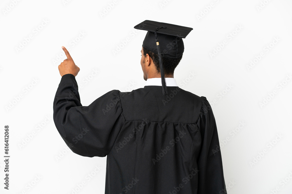 African American university graduate man over isolated white background pointing back with the index finger African American university graduate man over isolated white background pointing back with the index finger