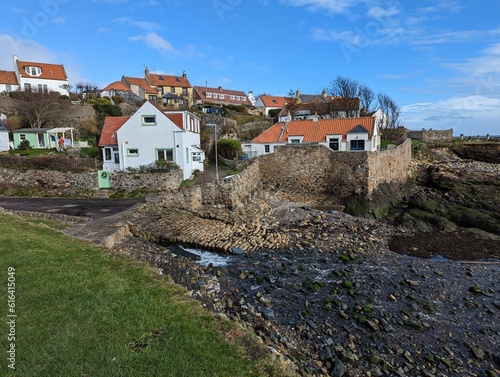 A view across the village houses of St. Monans sitting on a hillside above the Firth of Forth in Scotland, UK.