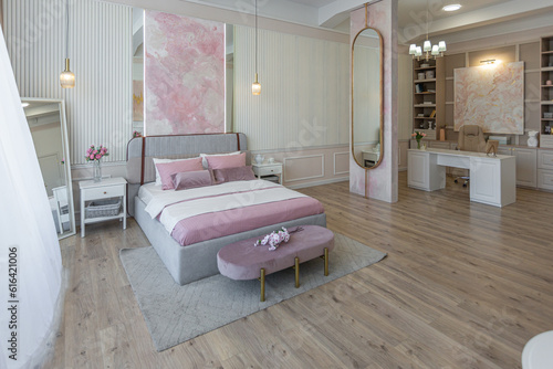 modern cozy soft interior design of a room with a bedroom and a home office in warm delicate pastel pink and beige colors © 4595886