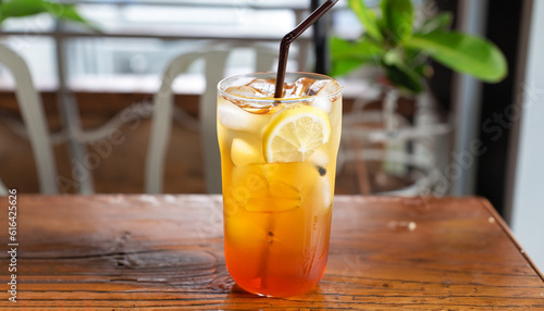 Refreshing with glass of Iced Tea add Lemon juice on wooden table mai tai