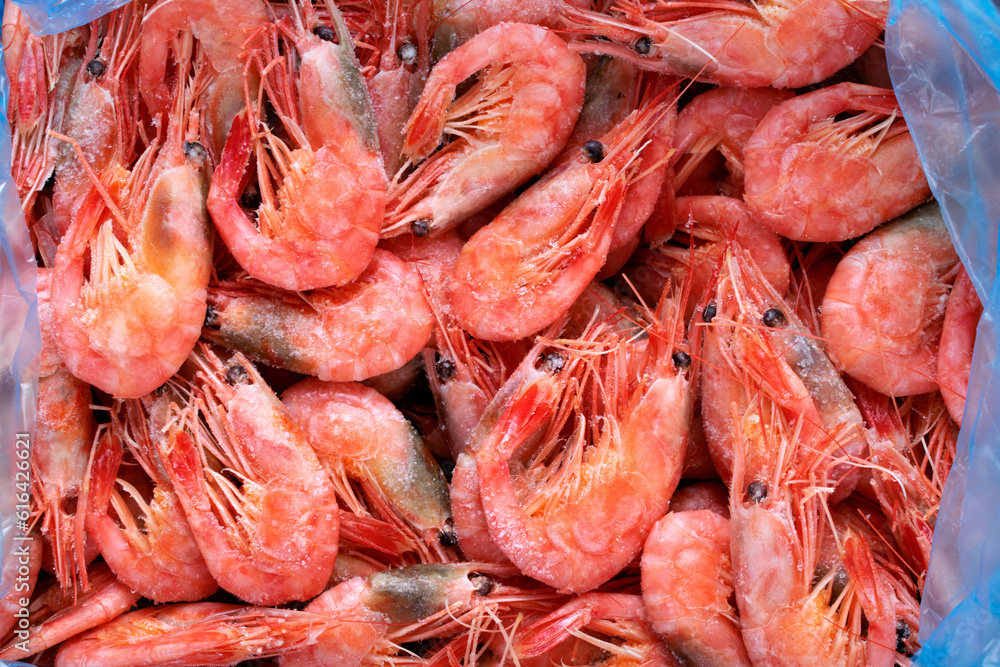 Frozen boiled shrimps. Seafood product. Full frame. Food background. Top view Frozen boiled shrimps. Seafood product. Full frame. Food background. Top view