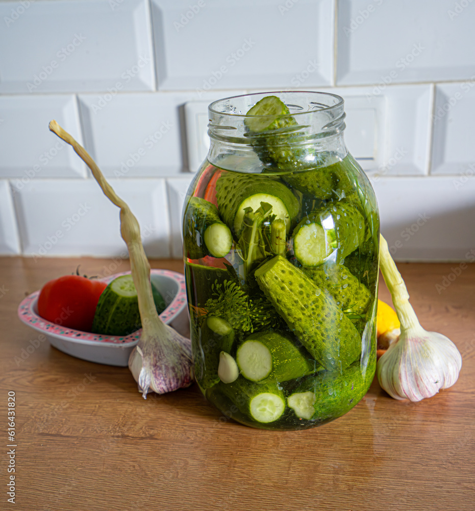 Fototapeta premium Ogórki zielone kiszone małosolne słoik. Pickled green cucumbers in a jar