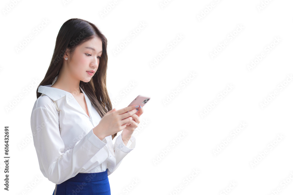Young Asian beautiful business woman stands while uses her smartphone to send messages to someone isolated on white background. Young Asian beautiful business woman stands while uses her smartphone to send messages to someone isolated on white background.