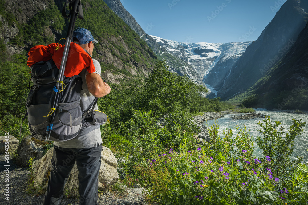 Caucasian Hiker Taking Quick Look on a Scenic Kjenndal Glacier Valley