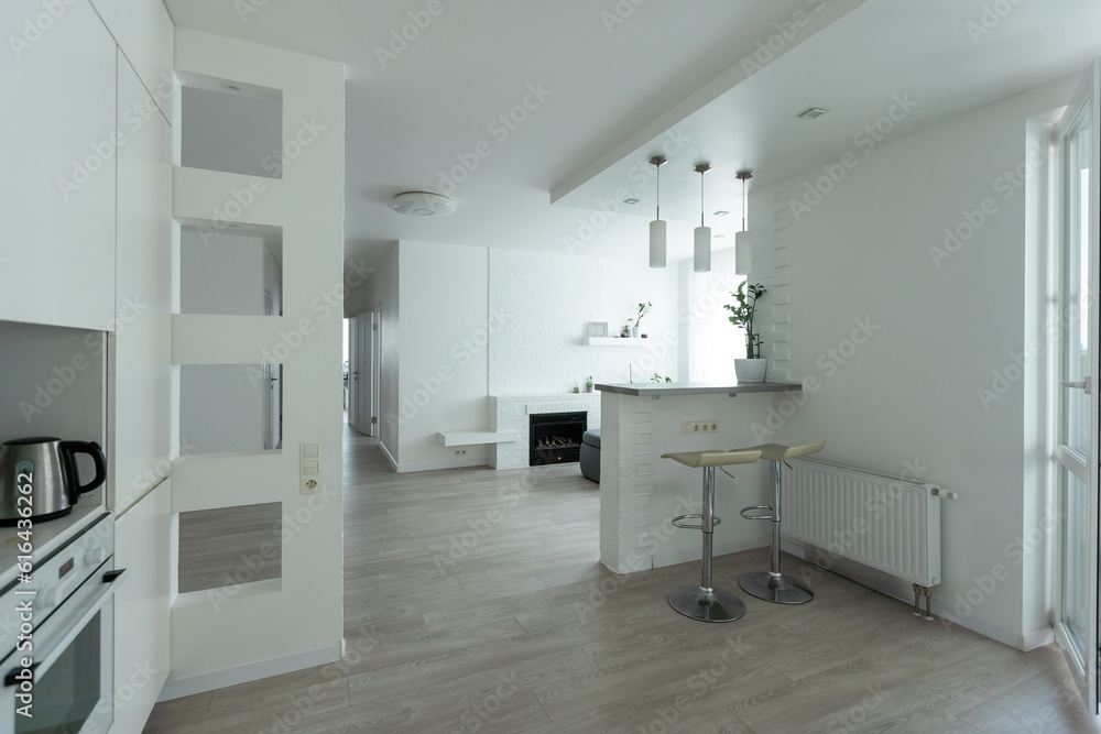 contemporary living room with open concept view through to dining room kitchen and a marble fireplace with gas fire contemporary living room with open concept view through to dining room kitchen and a marble fireplace with gas fire