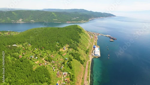 View of Lake Baikal, the village, the port at the source of the Angara River on a sunny summer day.