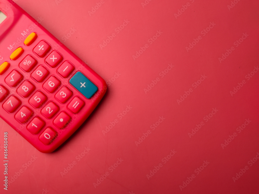 Top view red calculator on a red background - obrazy, fototapety, plakaty 