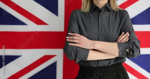 Wallpaper Mural Woman crosses arms confidently in front of British flag. Getting British citizenship and learning English Torontodigital.ca
