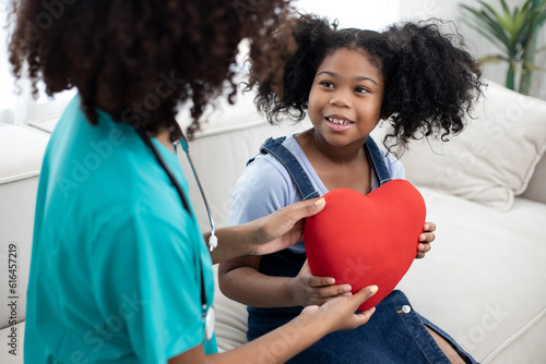 Young kid send heart shape for African American nurse to making for love in home health care.