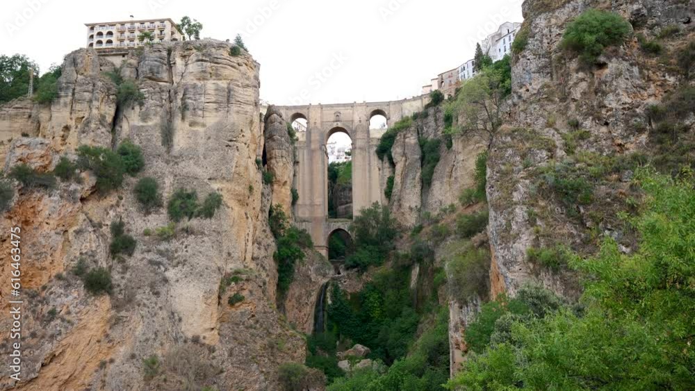 Tourists visit the panoramic landscape views looking over the Punte Nuevo Bridge in the southern region of Malaga in Spain Tourists visit the panoramic landscape views looking over the Punte Nuevo Bridge in the southern region of Malaga in Spain