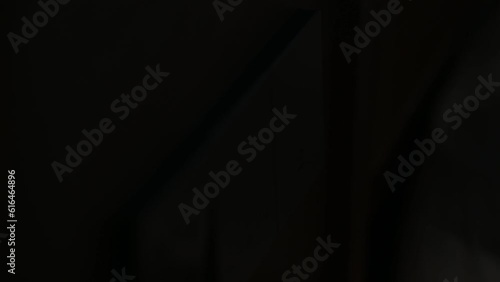 Close up male hand control the light to save electrical energy. Finger pushing light switch turn on or off.
