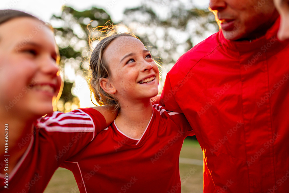 © Austockphoto - Close-up of female tween football team players in a huddle preparing for a game © Austockphoto - Close-up of female tween football team players in a huddle preparing for a game
