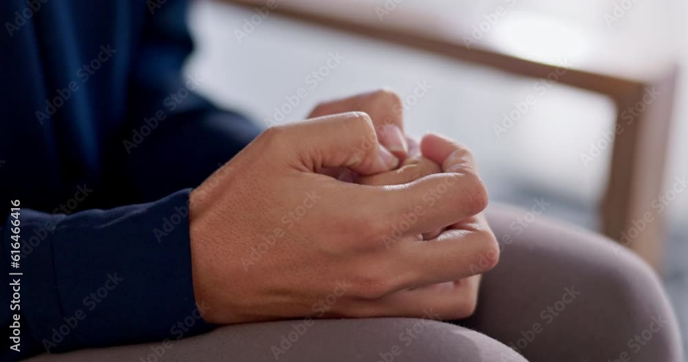 Hands, anxiety and stress with a nervous person sitting on a sofa in the living room of a home closeup. Mental health, psychology or fear with scared woman thinking about ptsd after abuse in therapy