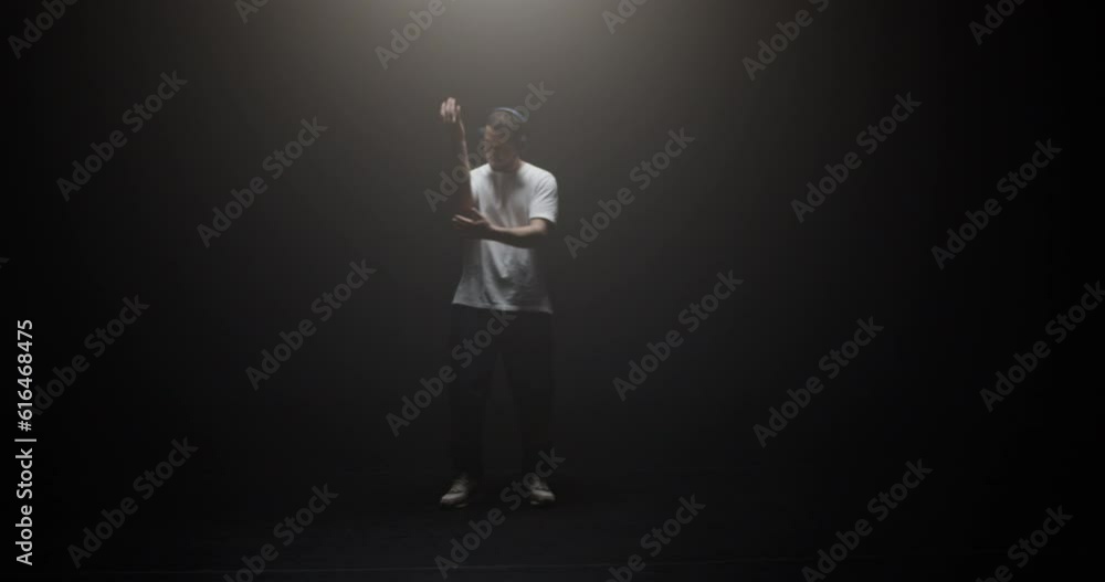 Freestyle dancer performing in spotlight Freestyle dancer performing in spotlight