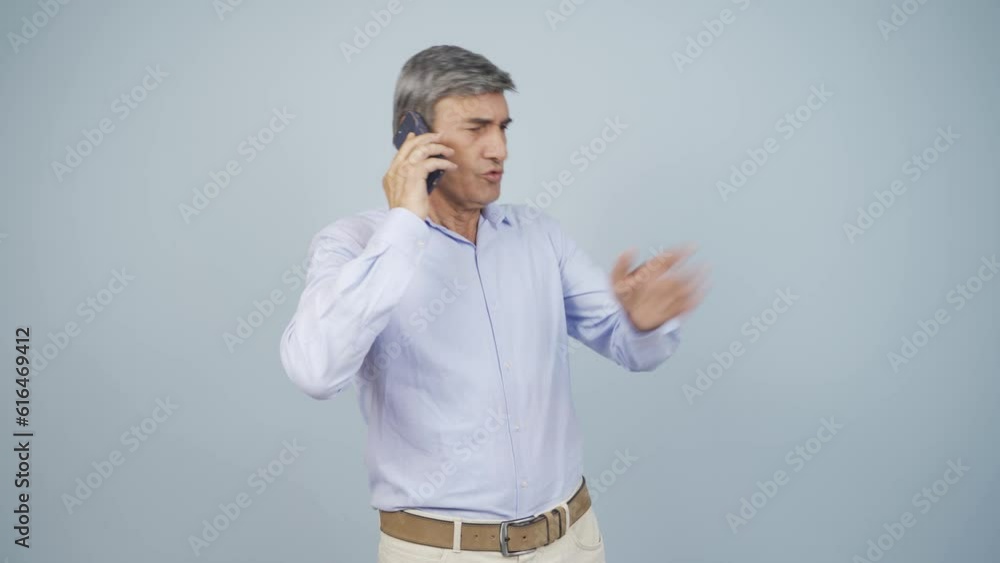 Angry old man talking on the phone. Angry old man talking on the phone.