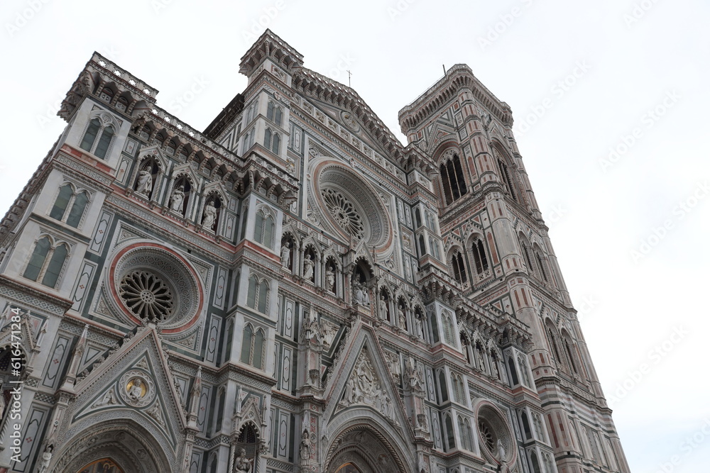Bottom view of the front of the cathedral of Santa Maria del Fiore, cloudy day, Florence, Italy.
