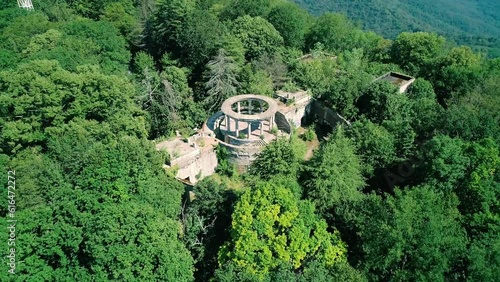 Aerial view of the abandoned building of the former restaurant among the trees on the top of Mount Akhun, Sochi, Russia. photo