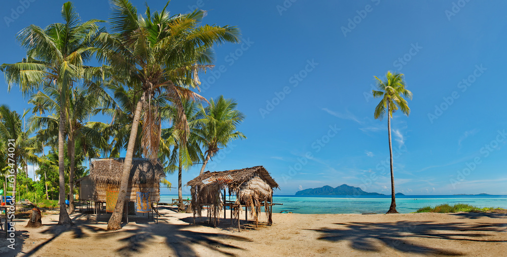 Malaysia. The island of Borneo. Fishing village of sea gypsies on one of the many reef islands with sandy shores and palm trees, from which all the huts are built.