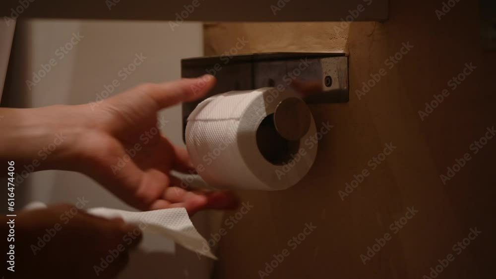A person is using a roll of toilet paper. This close up video shows