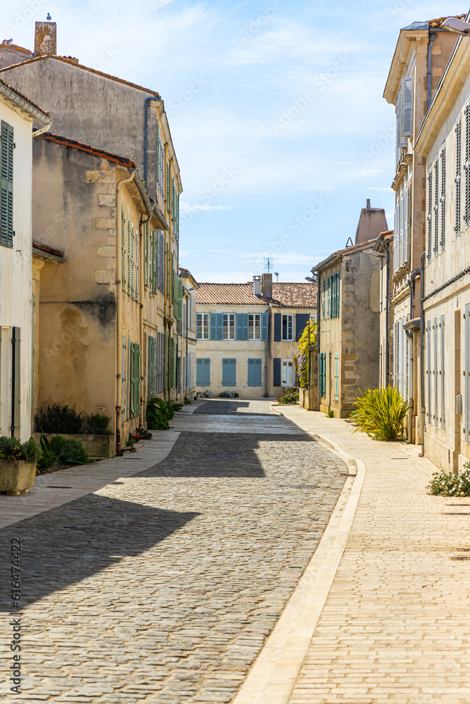 Narrow traditional street of the town of Saint-Martin-de-Ré, France on a sunny day