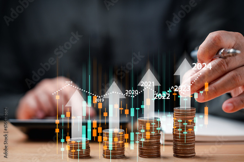 businessman analyzing stock trading graph financial data. Coins tower stacked on desk wooden, Business finance and saving money investment, Money coin stack growing graph concept. Balance savings.