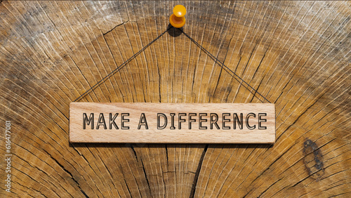 The sentence We believe in making a difference was written. Wooden concept studio shoot