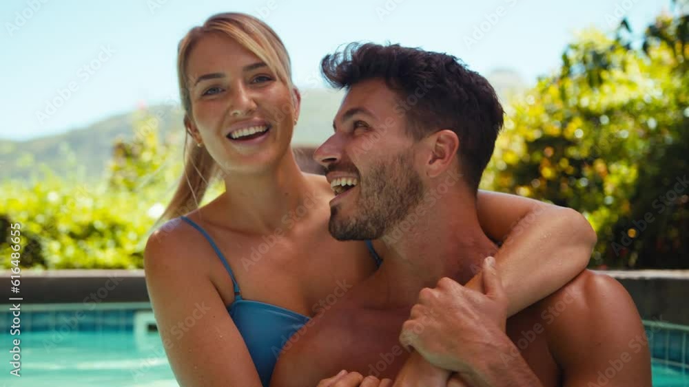 Portrait of smiling couple on holiday hugging in swimming pool - shot in slow motion Portrait of smiling couple on holiday hugging in swimming pool - shot in slow motion