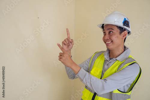 Young construction guys wear the wearpack and helmet show the click thumbnail pose. The photo is suitable to use for click thumbnail product and ecommerce promotion.