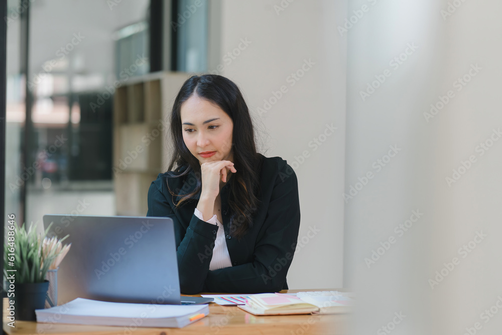Young Indian Accountant Woman in casuals working on financial analysis documents with a tense expression in the office. Business finance and accounting concepts. Young Indian Accountant Woman in casuals working on financial analysis documents with a tense expression in the office. Business finance and accounting concepts.