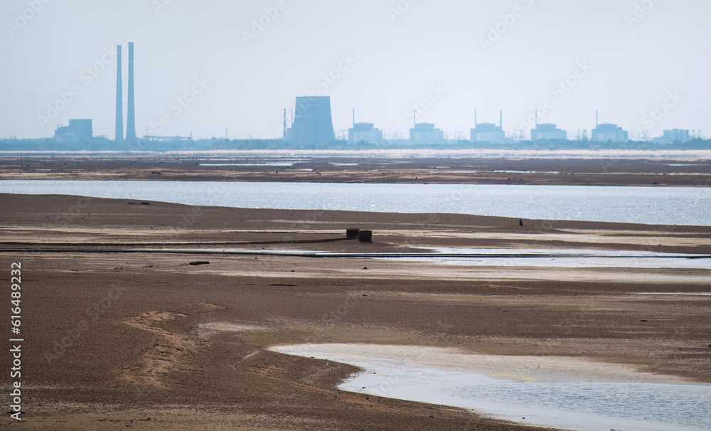 Terrible Disaster Ecocide landscape of dried up Kakhovka Reservoir in Zaporizhzhia region as a result of Kakhovka Dam damaging on 6 June 2023 with Zaporizhzhia thermal power station largest in Europe